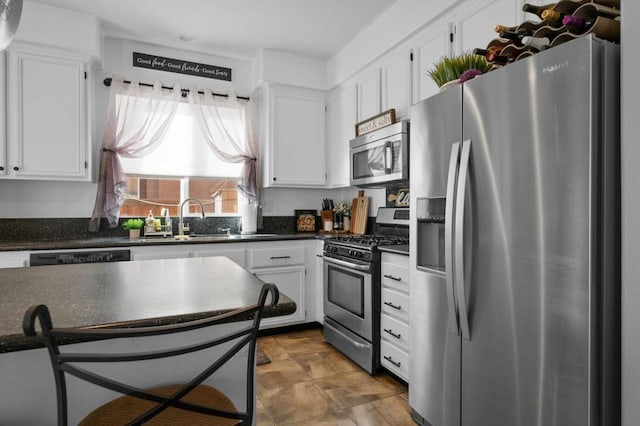 kitchen with white cabinetry, sink, and stainless steel appliances