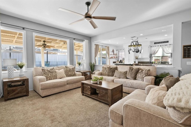 carpeted living room featuring ceiling fan