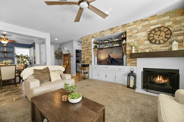 carpeted living room with a tiled fireplace