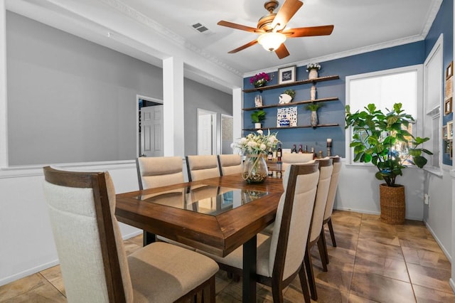 tiled dining room with crown molding and ceiling fan