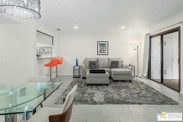 living room featuring crown molding, light tile patterned floors, and an inviting chandelier