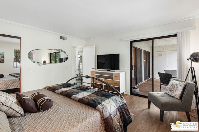 bedroom with hardwood / wood-style flooring and crown molding