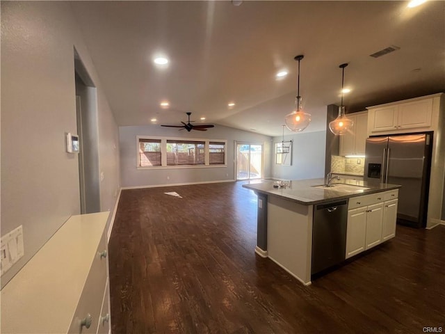 kitchen with white cabinetry, stainless steel appliances, dark hardwood / wood-style flooring, an island with sink, and vaulted ceiling