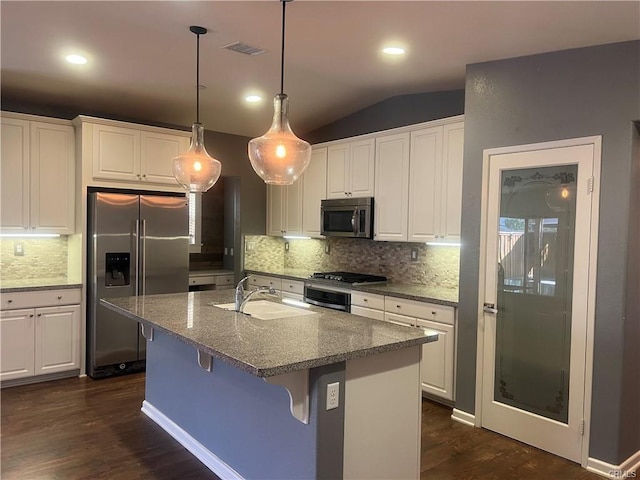 kitchen featuring sink, white cabinets, lofted ceiling, and appliances with stainless steel finishes