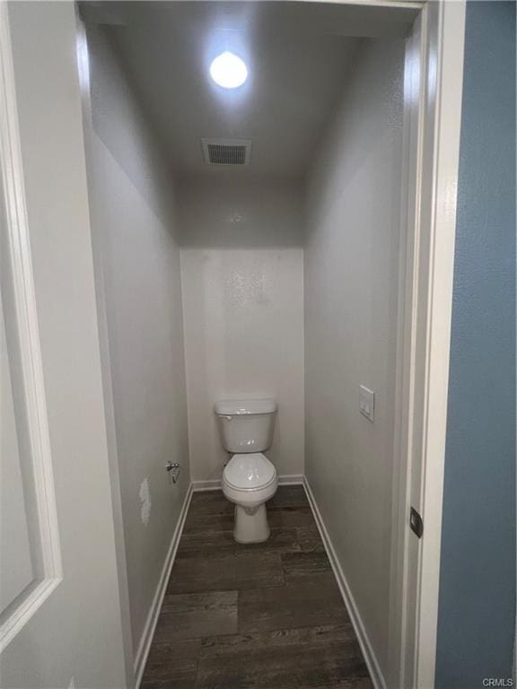 bathroom featuring toilet and hardwood / wood-style flooring