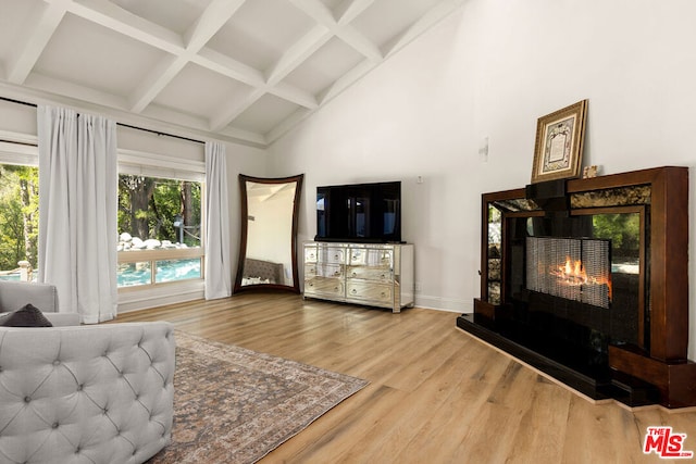 living room featuring hardwood / wood-style floors, beam ceiling, and coffered ceiling