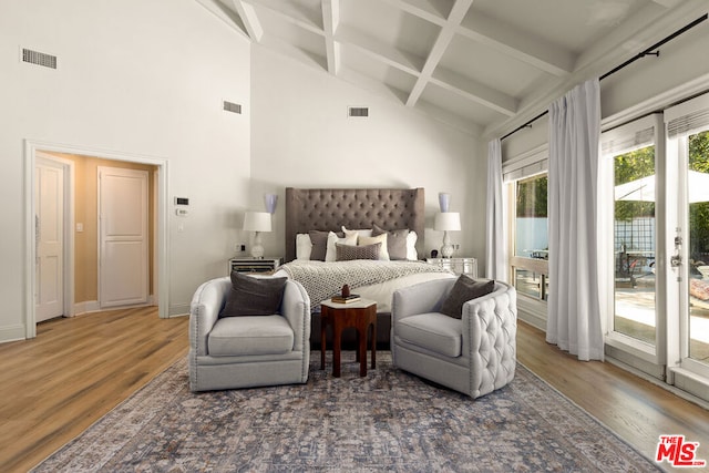 bedroom featuring access to exterior, beamed ceiling, high vaulted ceiling, and hardwood / wood-style flooring