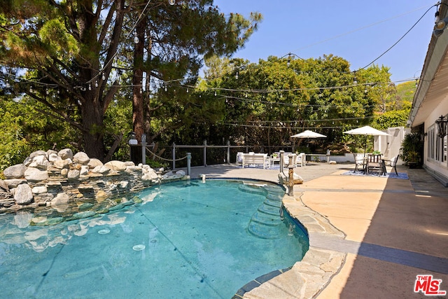 view of swimming pool featuring a patio