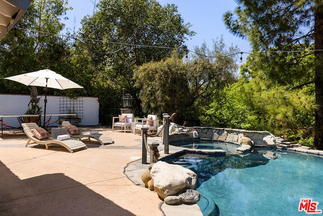 view of pool featuring an in ground hot tub and a patio