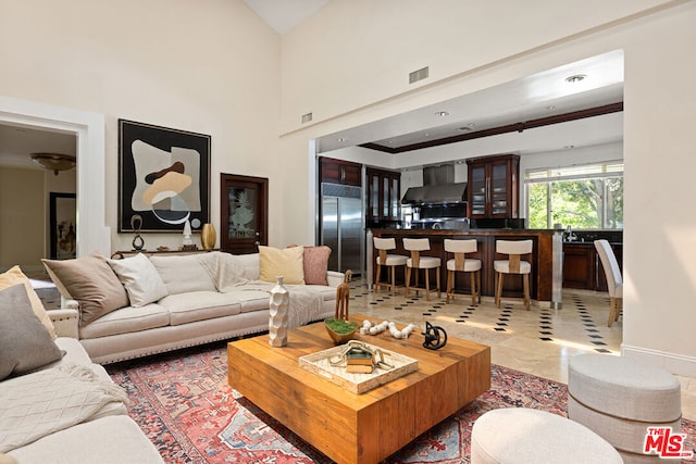 living room featuring a towering ceiling