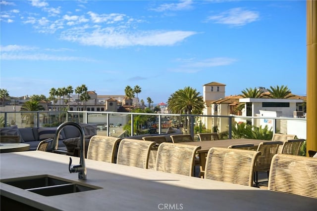 view of patio / terrace with sink and a balcony