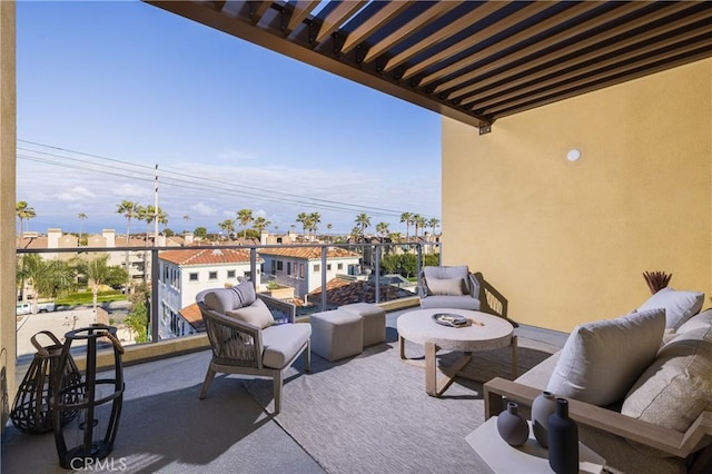 balcony featuring an outdoor living space with a fire pit