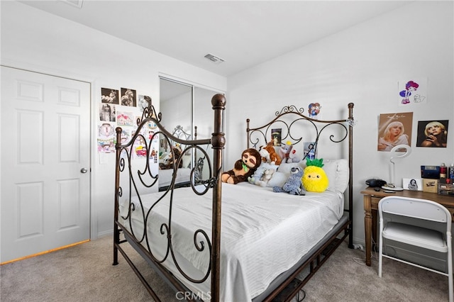 bedroom with carpet floors, a closet, and vaulted ceiling