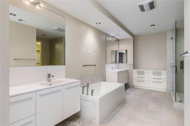 bathroom with tile patterned floors, vanity, and independent shower and bath