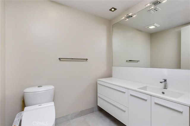 bathroom featuring vanity and toilet