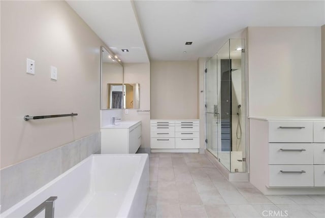 bathroom featuring tile patterned floors, vanity, and shower with separate bathtub