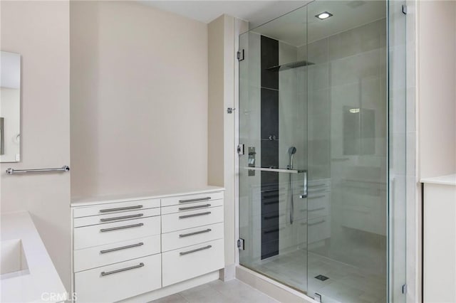 bathroom featuring vanity, tile patterned floors, and walk in shower