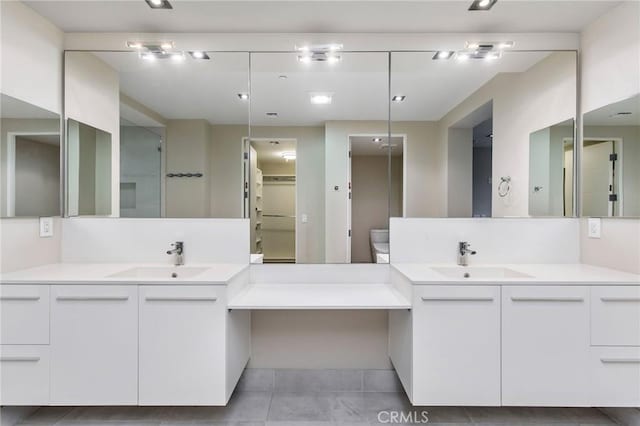 bathroom with tile patterned flooring, vanity, and toilet