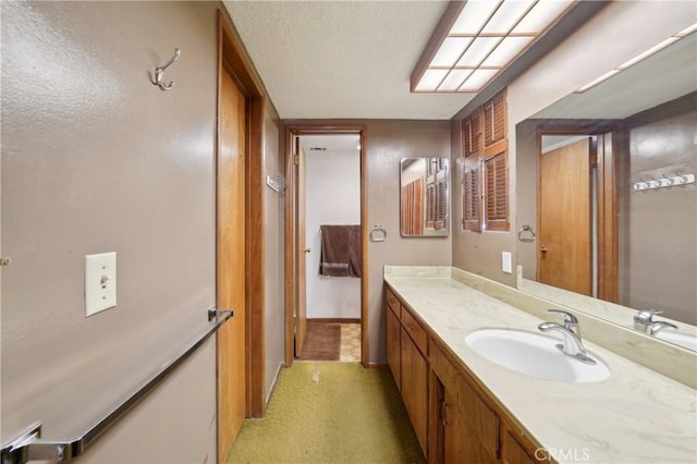 bathroom featuring a textured ceiling and vanity