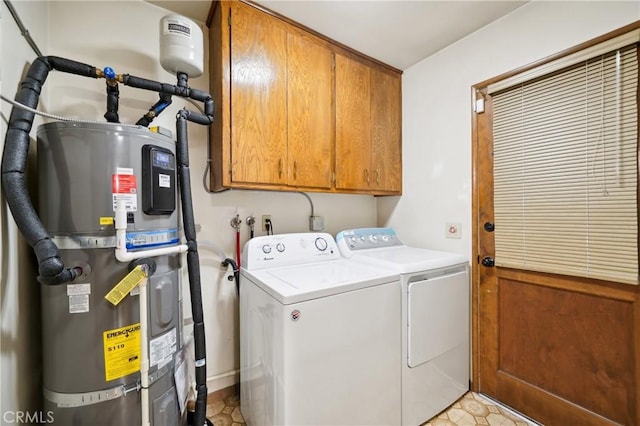 laundry room with strapped water heater, cabinets, and independent washer and dryer