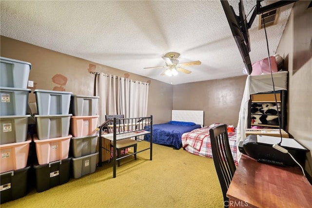 carpeted bedroom with a textured ceiling and ceiling fan