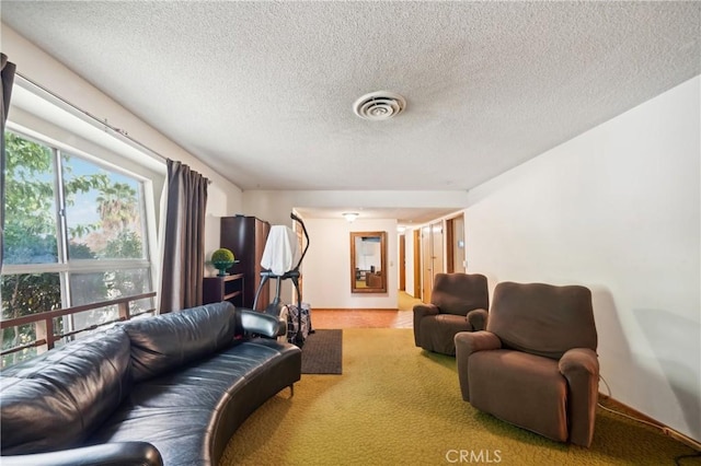 living room featuring light carpet and a textured ceiling