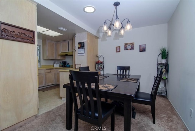 dining space with light carpet and an inviting chandelier