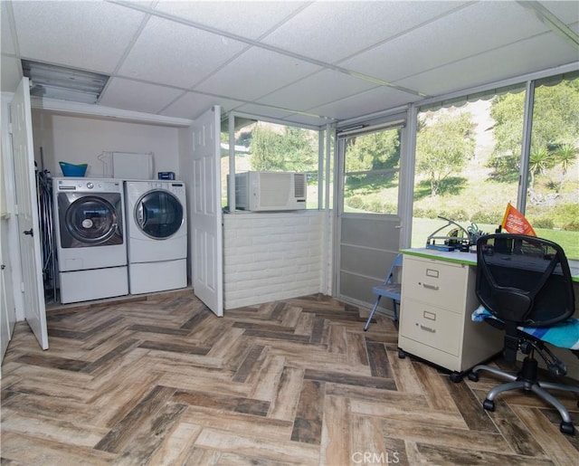 washroom with a healthy amount of sunlight, cooling unit, independent washer and dryer, and dark parquet flooring