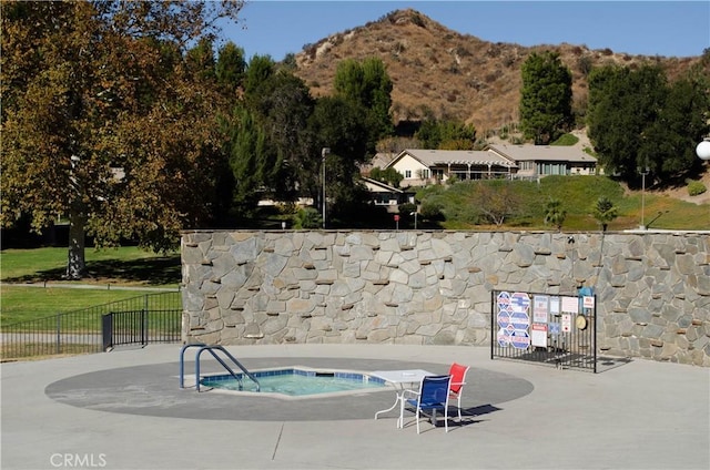 view of pool featuring a mountain view and a community hot tub