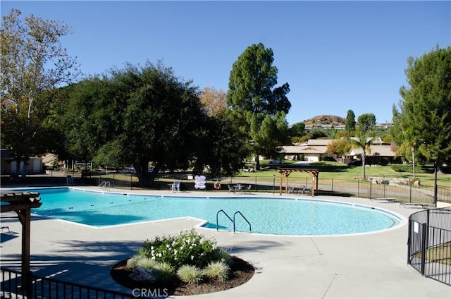 view of swimming pool featuring a patio and a pergola