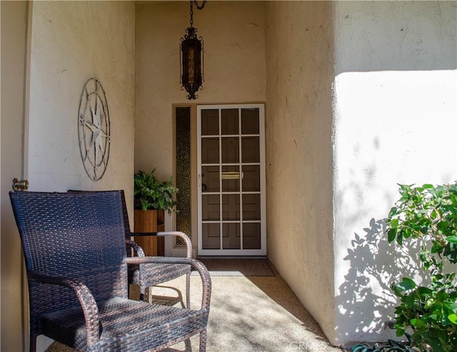 view of exterior entry with a patio area