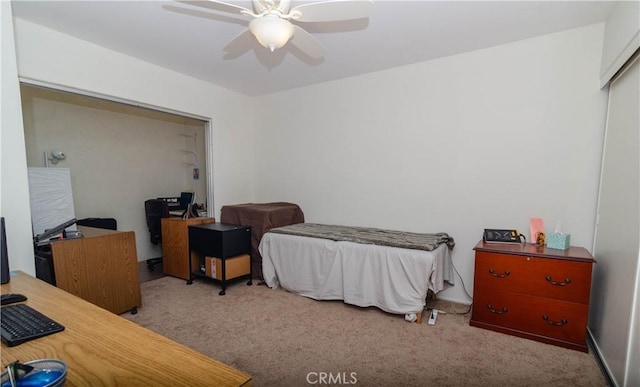 bedroom featuring ceiling fan, light colored carpet, and a closet