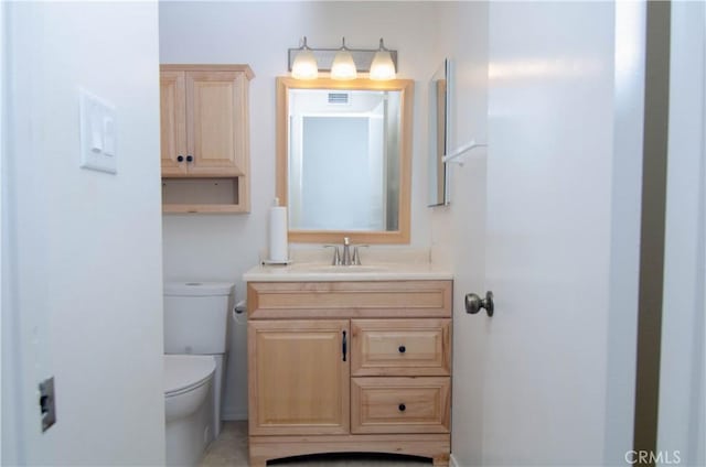 bathroom featuring toilet and vanity