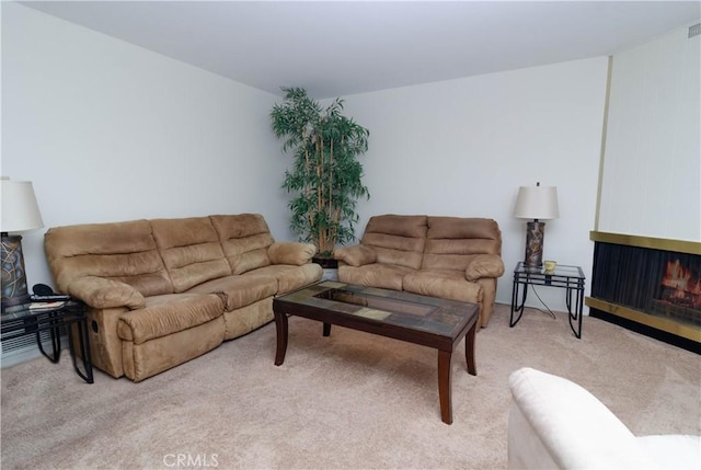 carpeted living room with a multi sided fireplace