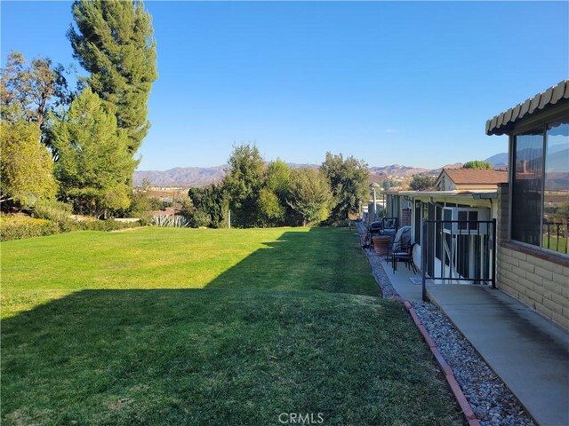 view of yard with a mountain view and a patio area