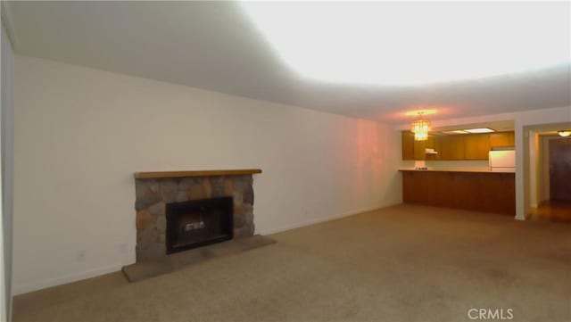 unfurnished living room featuring light colored carpet and a stone fireplace