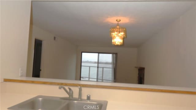 kitchen with sink, a chandelier, and hanging light fixtures