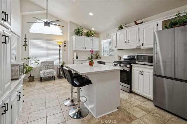 kitchen with white cabinets, a healthy amount of sunlight, and stainless steel appliances