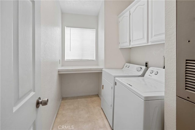 laundry area with cabinets and separate washer and dryer