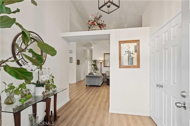 hallway with light hardwood / wood-style flooring