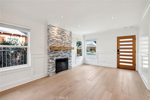 3821 S Muirfield Rd, Los Angeles, CA 90008 - unfurnished living room featuring hardwood / wood-style flooring, healthy amount of natural light, a decorative wall, a fireplace, and crown molding