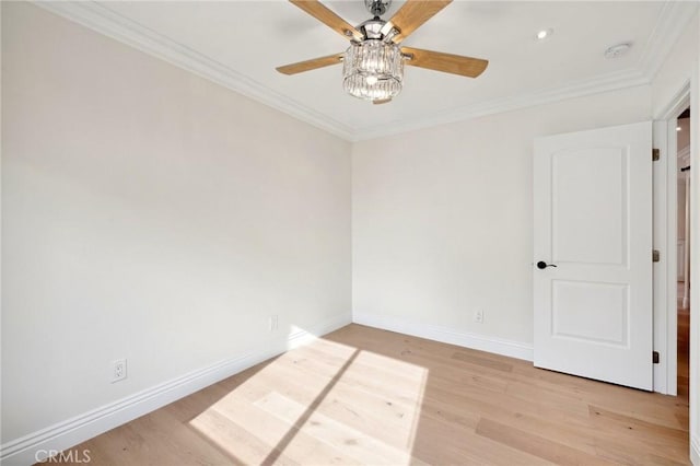 empty room with crown molding and light wood-type flooring