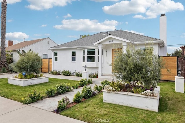 3821 S Muirfield Rd, Los Angeles, CA 90008 - view of front of property featuring stucco siding, a chimney, and a shingled roof