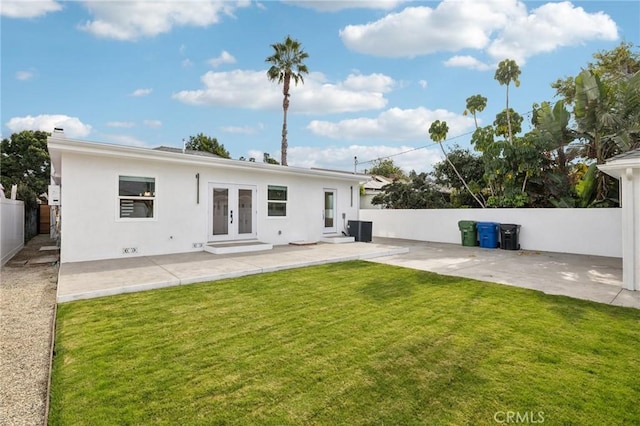 rear view of house featuring a lawn, a patio area, french doors, and cooling unit