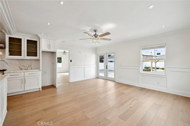 3821 S Muirfield Rd, Los Angeles, CA 90008 - unfurnished living room featuring ceiling fan, healthy amount of natural light, ornamental molding, french doors, and light wood finished floors