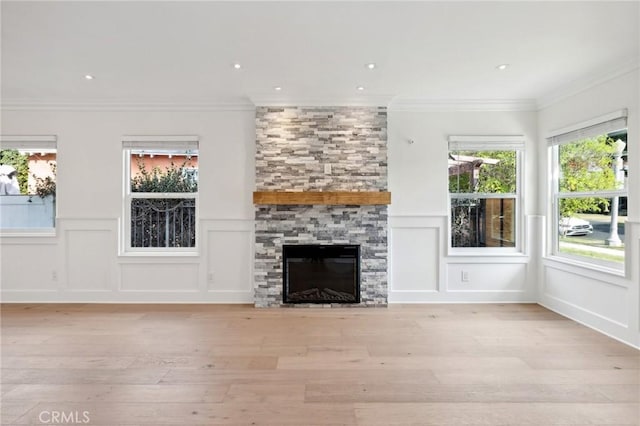 3821 S Muirfield Rd, Los Angeles, CA 90008 - unfurnished living room with a decorative wall, light wood-type flooring, ornamental molding, a fireplace, and a wainscoted wall