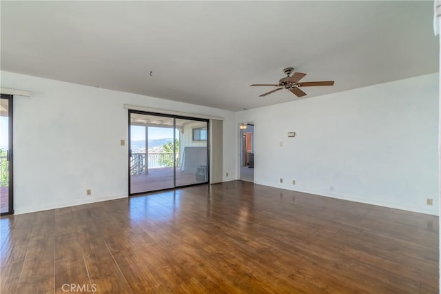 unfurnished room with ceiling fan and dark hardwood / wood-style flooring