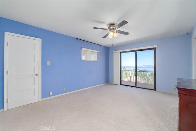 carpeted empty room featuring ceiling fan