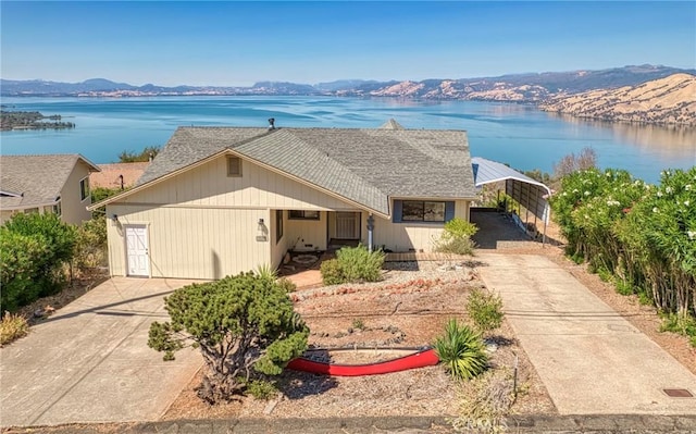 view of front facade with a carport and a water and mountain view