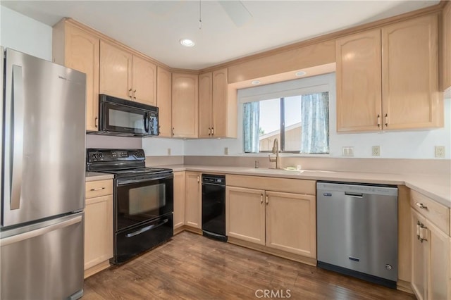 kitchen featuring black appliances, light brown cabinets, and dark hardwood / wood-style flooring